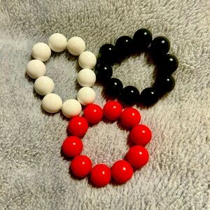 Set of 3 bracelets in Red, Black and White. Wear as a set or mix and match.